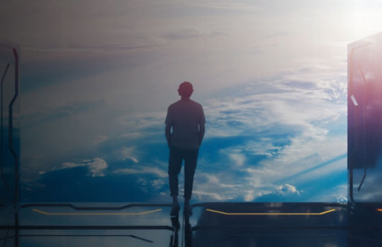 A man standing near a space station window looking out in space