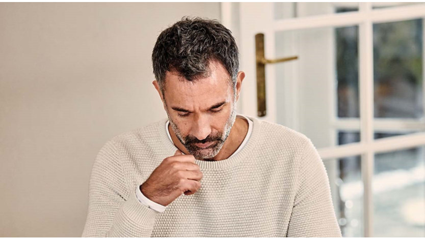 A Male business owner working at home desk on his tablet