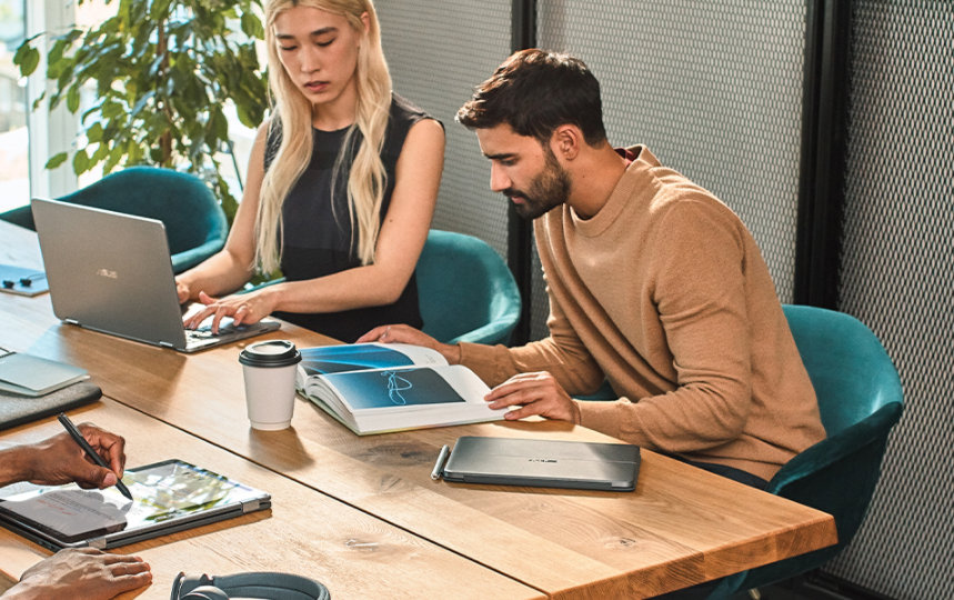 image of three people, one female, two male, working in a casual office space on Surface devices