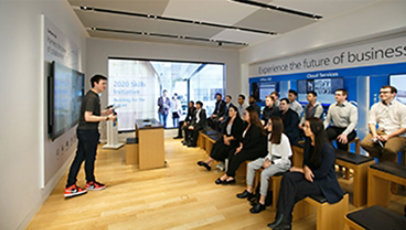 A trainee presenting in front of an audience