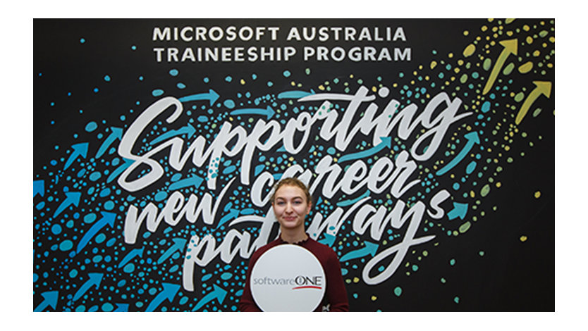 women standing and smiling front of the banner wall | Microsoft Australia Traineeship program Supporting new career pathways
