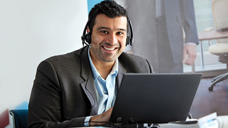 Man at work, on a conference call on laptop 