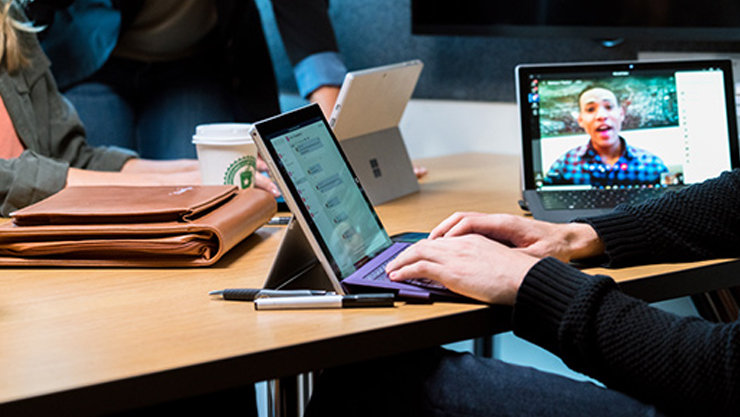 Close up of male college student‘s hands using Surface Pro