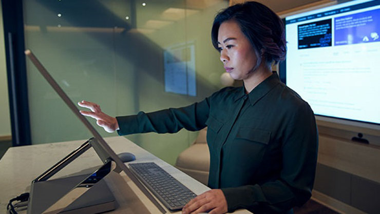 a girl in a collared shirt working on a touch device inside a cabin