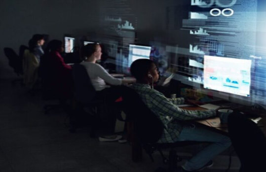 4 people working on devices.