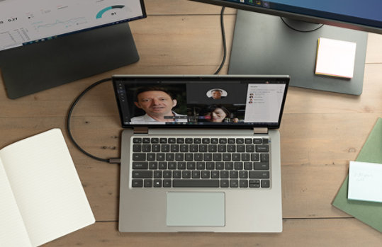 image of a laptop connected to 2 other computer screens on a table
