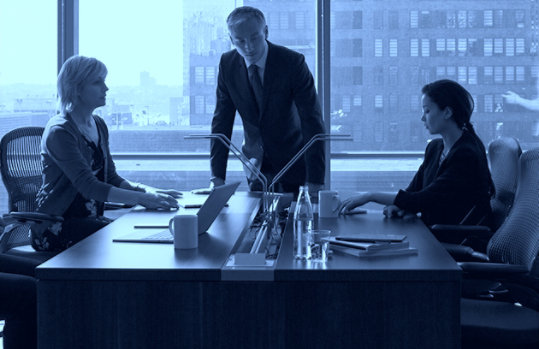 3 people at a desk