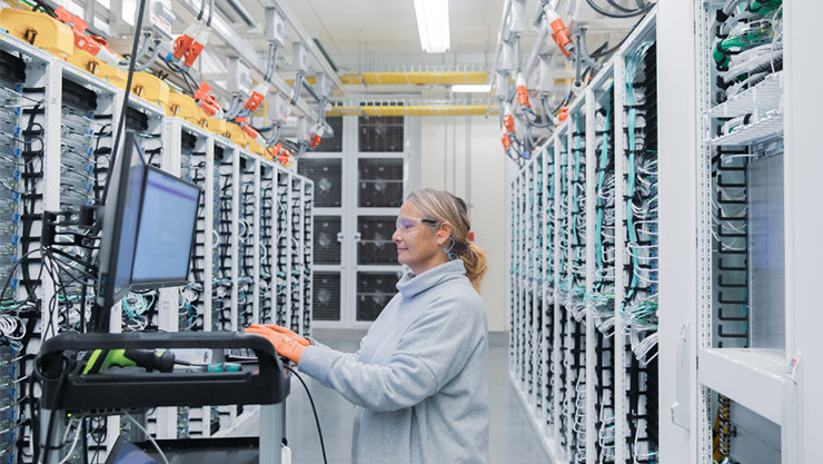 Researcher working at a terminal station in a data center