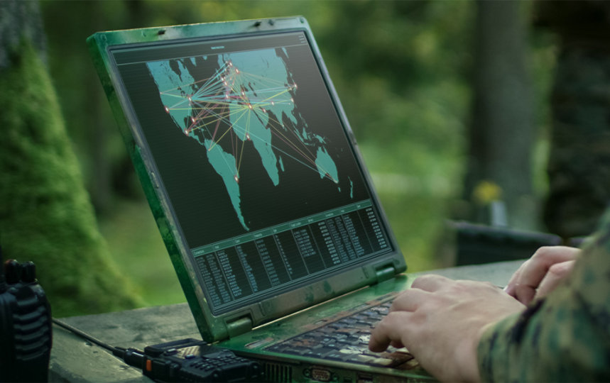 A soldier's hands seems working on laptop