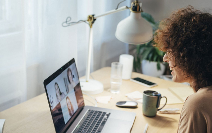 Woman mid-discussion on a virtual meeting as she works from her home office