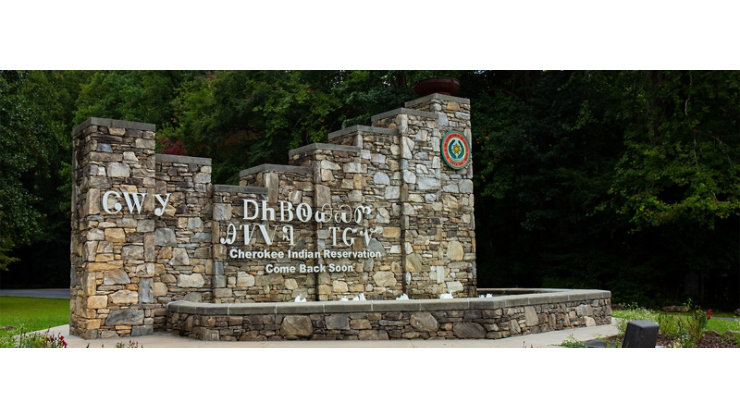 A stonework welcome sign for the Eastern Band of Cherokee Indians’ reservation in Cherokee, North Carolina. The sign is written using both the Cherokee syllabary as well as the English translation which reads ‘Cherokee Indian Reservation / Come Back Soon.’