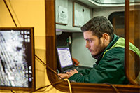 Field worker monitoring footage from a field post.