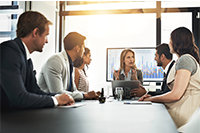 Group of federal government employees sit around a conference table having a discussion.