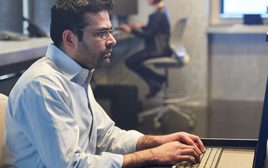 man working on secure laptop at desk