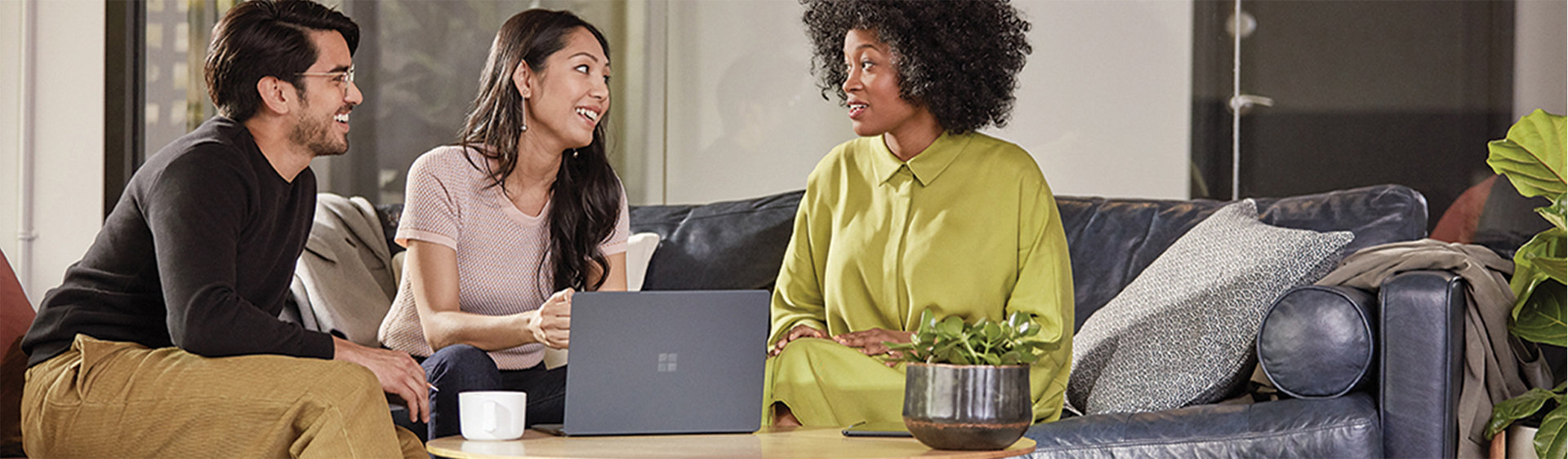 three people having a conversation with a surface