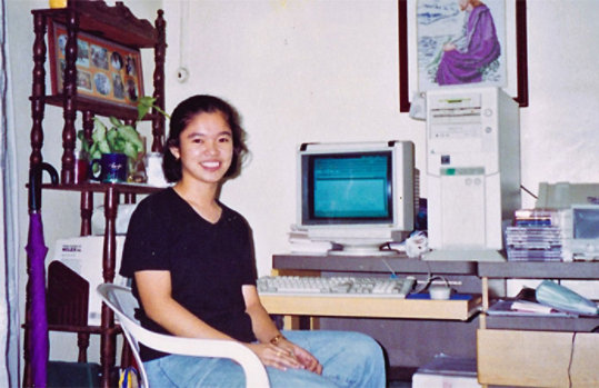 Arlene as a child next to a computer