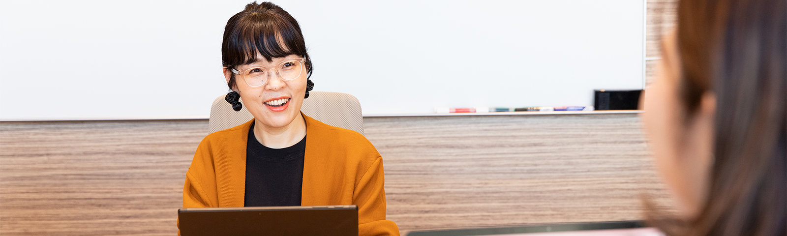 他の社員と話をする Naho さん