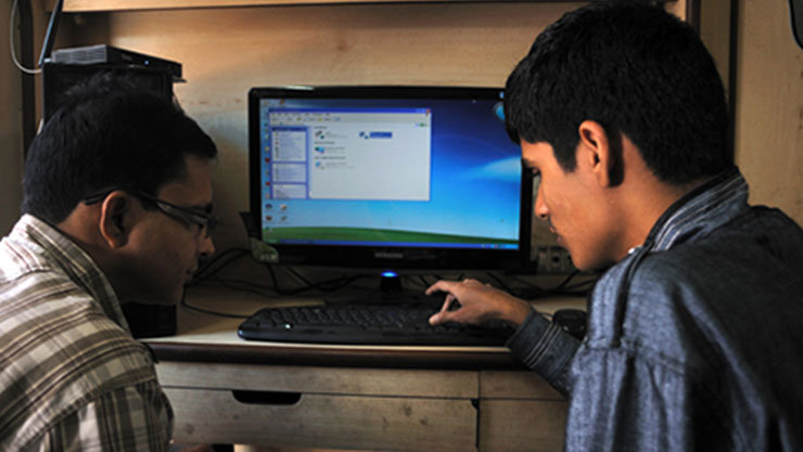 Two people with disability working on a computer