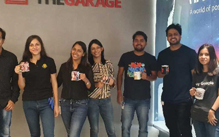 guys posing for camera some having their coffee mugs on