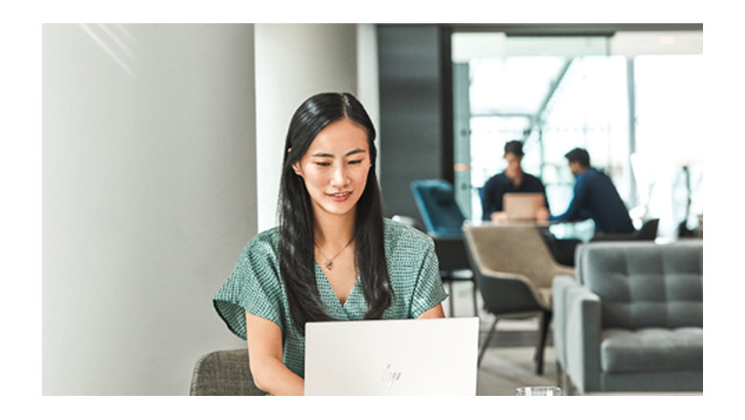 A woman using her laptop at a lounge area