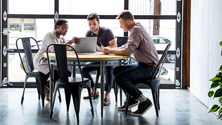 Three employees in discussion to find a solution