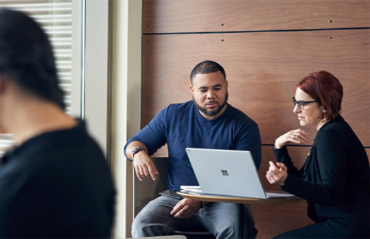 A male and female employee in discussion