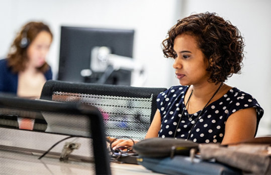 Two female employees working in the office