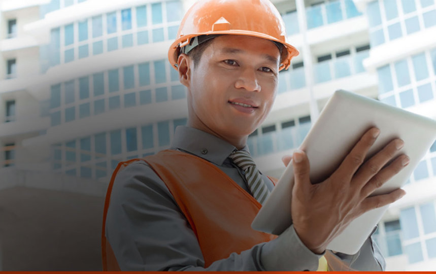 Male architect working with laptop at the construction site