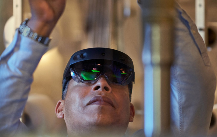 A textile manufacturing factory worker using remote assist on Hololens2 on the warehouse floor