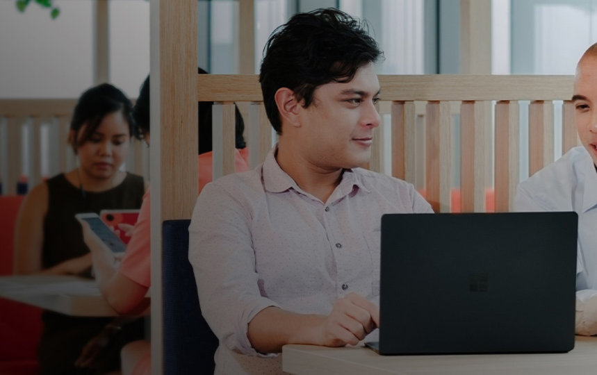 Two friends looking at a laptop