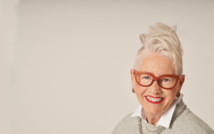 Smiling portrait of an woman with red glasses and modern haircut