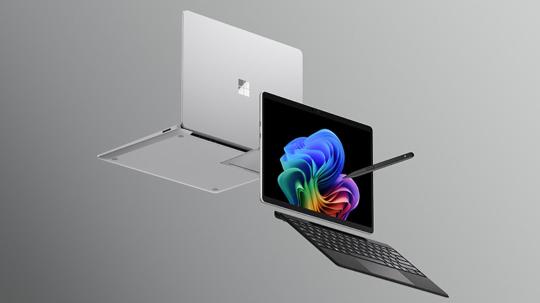 グレーの背景に浮かぶ、Microsoft SurfaceノートPCとキーボード・タッチペン付きのSurface Proタブレット。