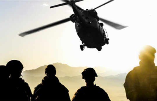 Silhouettes of soldiers during a military mission at sunset