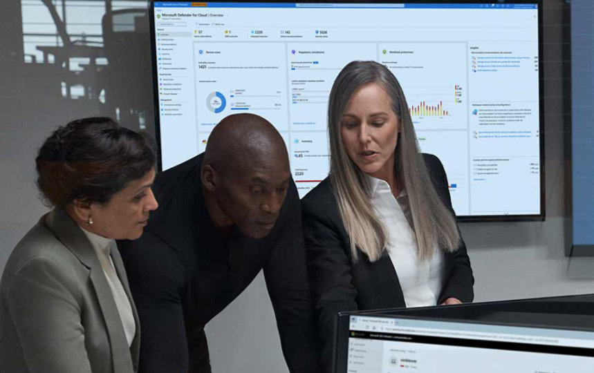 coworkers looking at computer screens