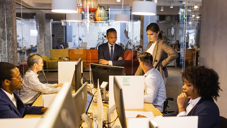 team of professionals working on computers in an office