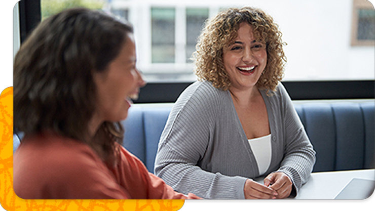 Two women laughing in the office