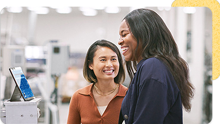 Two woman looking a laptop together at work.