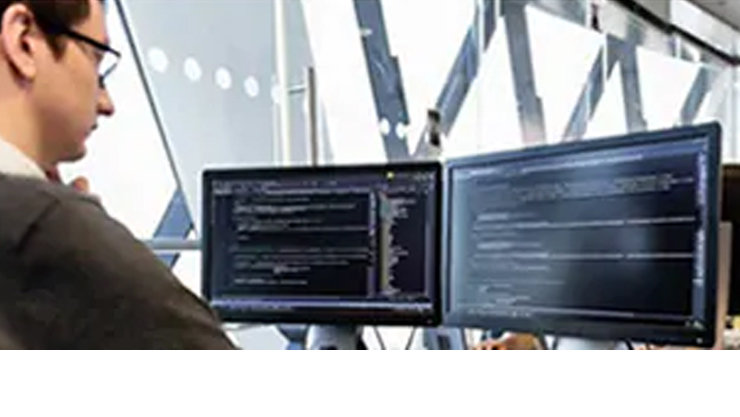 멀티스크린 데스크탑에서 코딩하는 남자