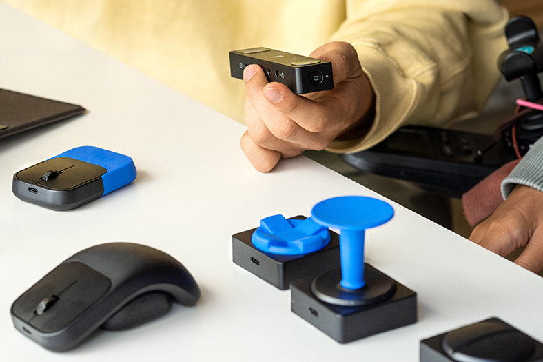 A close-up of accessories available from Microsoft Adaptive accessories, including a mouse with different handle options.