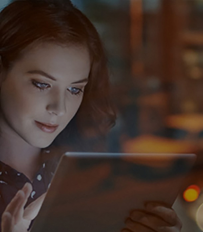 a close up of a woman browsing a tablet