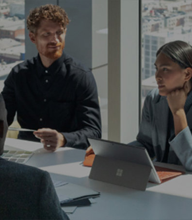 two men and a woman having a meeting in a high rise