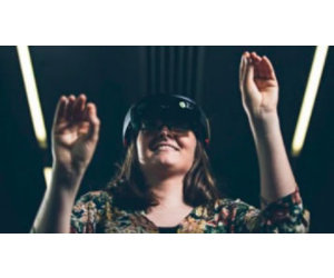 woman with hands in the air, happily using the HoloLens