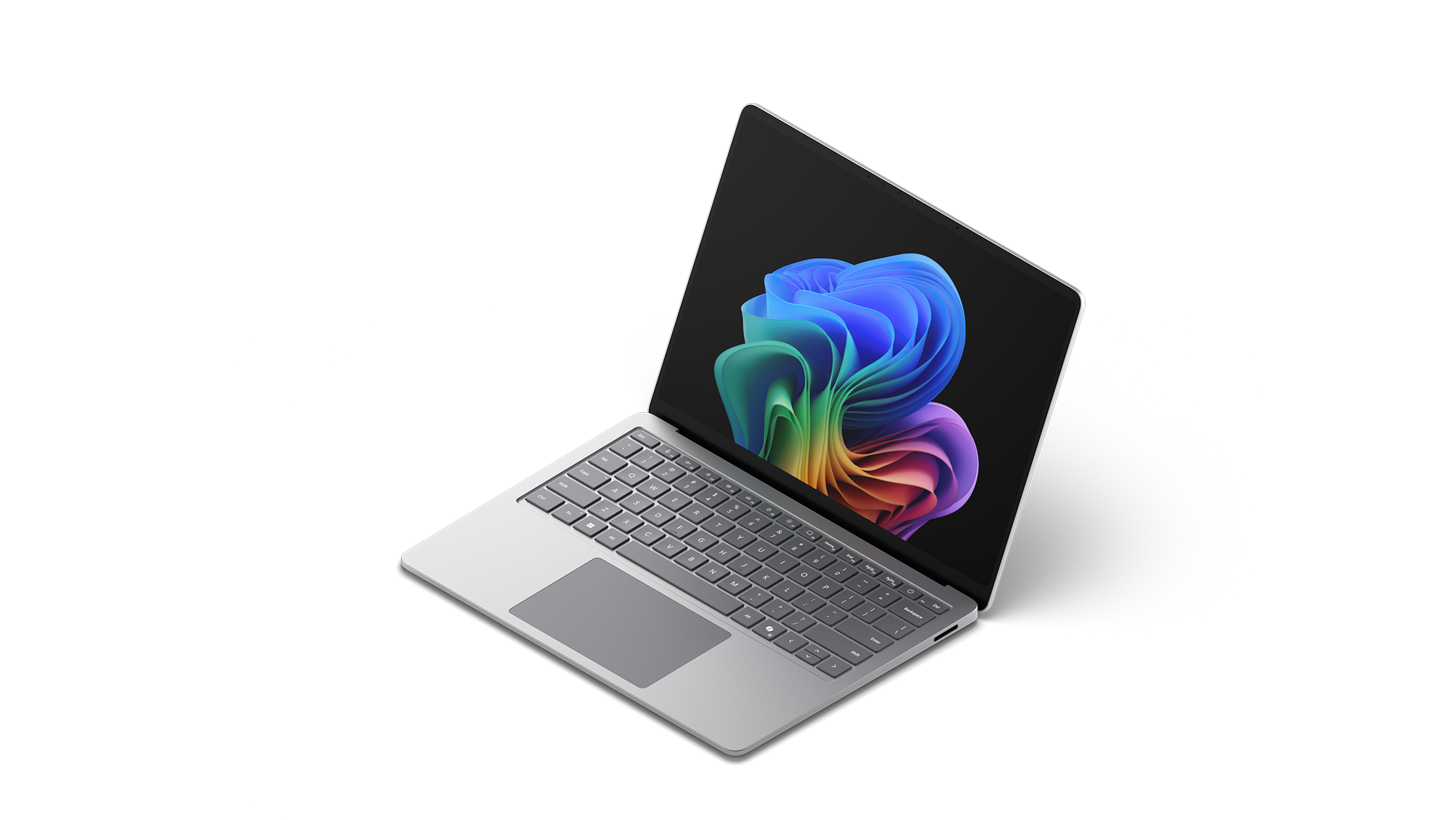 左向きに置かれた 法人向け Surface Laptop, 13.8/15 インチ | Intelに、レインボー ブルームの画像が表示されています。