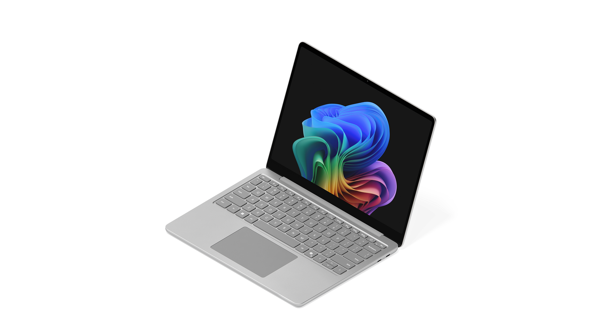 左向きに置かれた 法人向け Surface Laptop, 13 インチ | Intelに、レインボー ブルームの画像が表示されています。