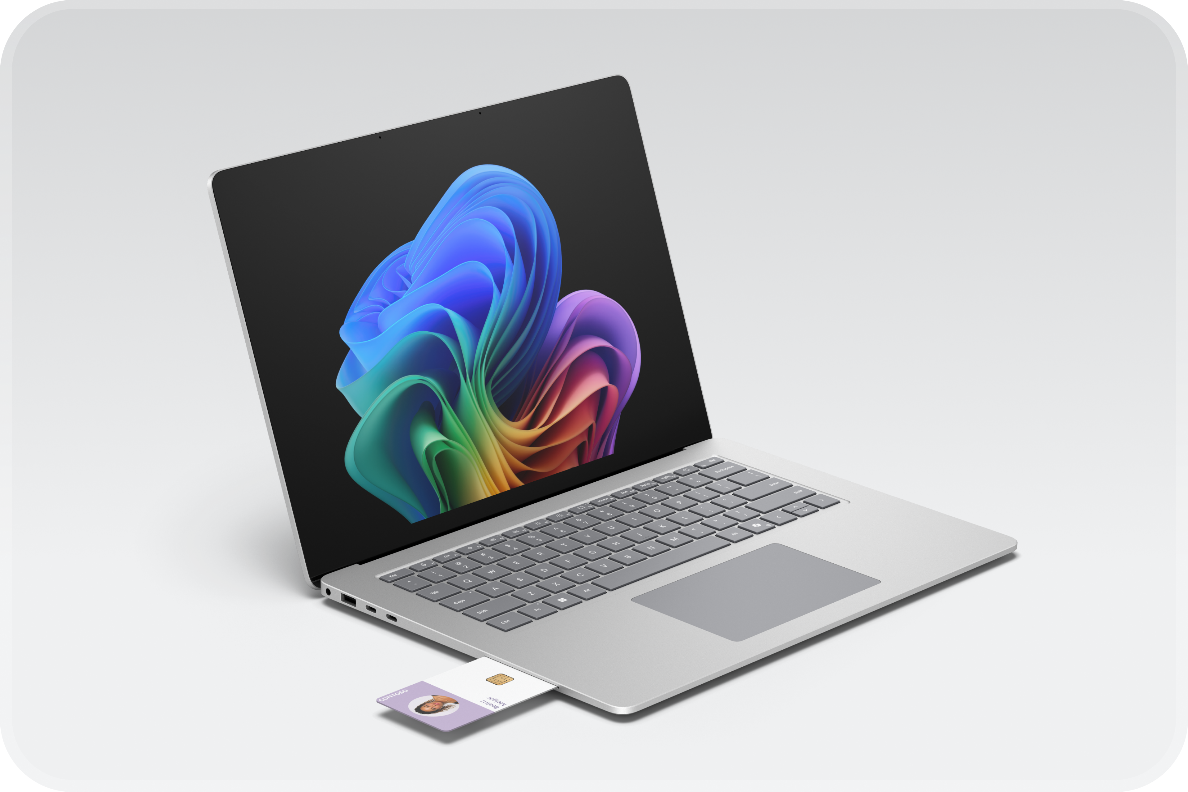 Un ordinateur portable Windows platine ouvert affiche l'image de la fleur arc-en-ciel et une carte à puce sécurisée avec des options d'authentification, notamment une récupération simplifiée avec Pluton, BitLocker et Windows Hello.