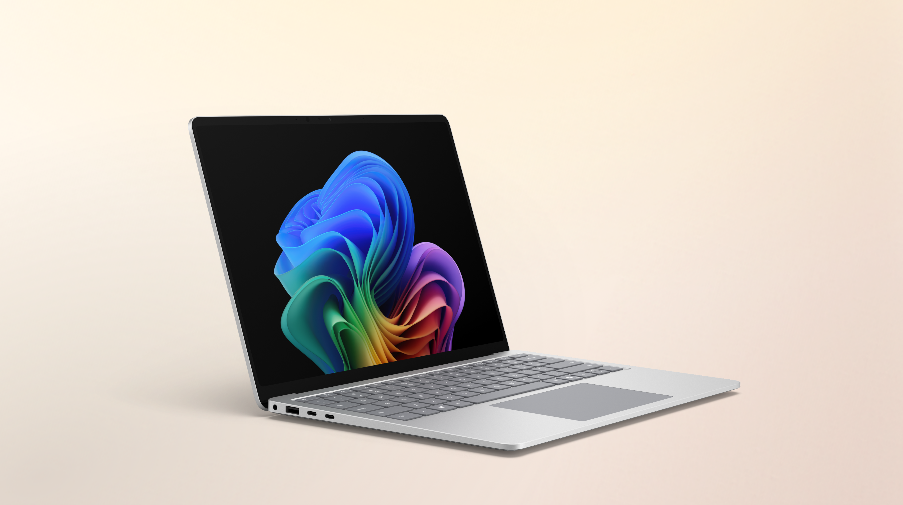 Un ordinateur portable Surface Laptop platine ouvert, compatible avec l'IA, avec la 5G en option, tourné vers la droite, affichant l'image de la fleur arc-en-ciel sur un fond pêche dégradé.