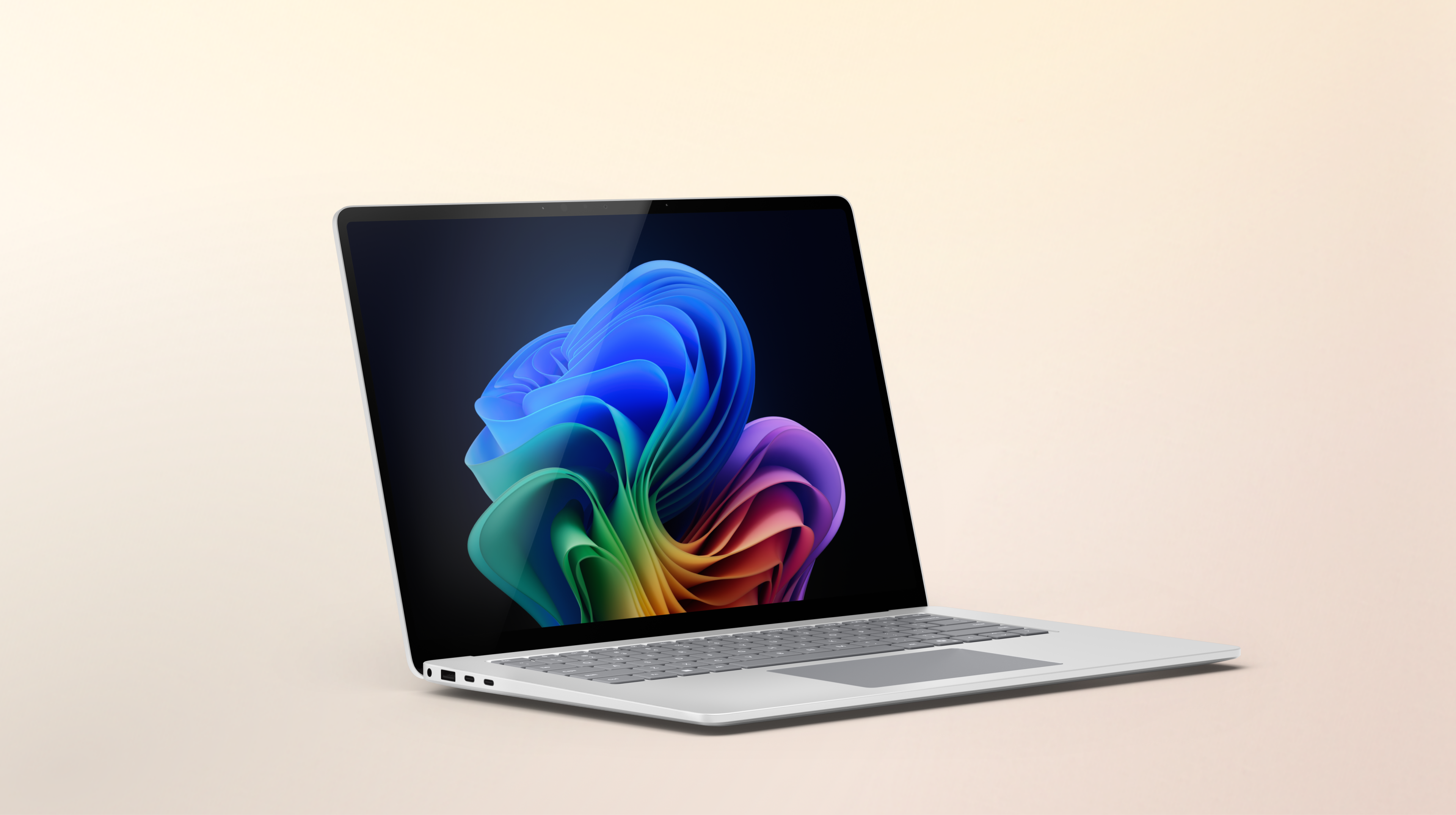 Un ordinateur portable Surface Laptop platine ouvert avec des outils d'IA intégrés orienté vers la droite, affichant l'image de la fleur arc-en-ciel sur un arrière-plan pêche dégradé.