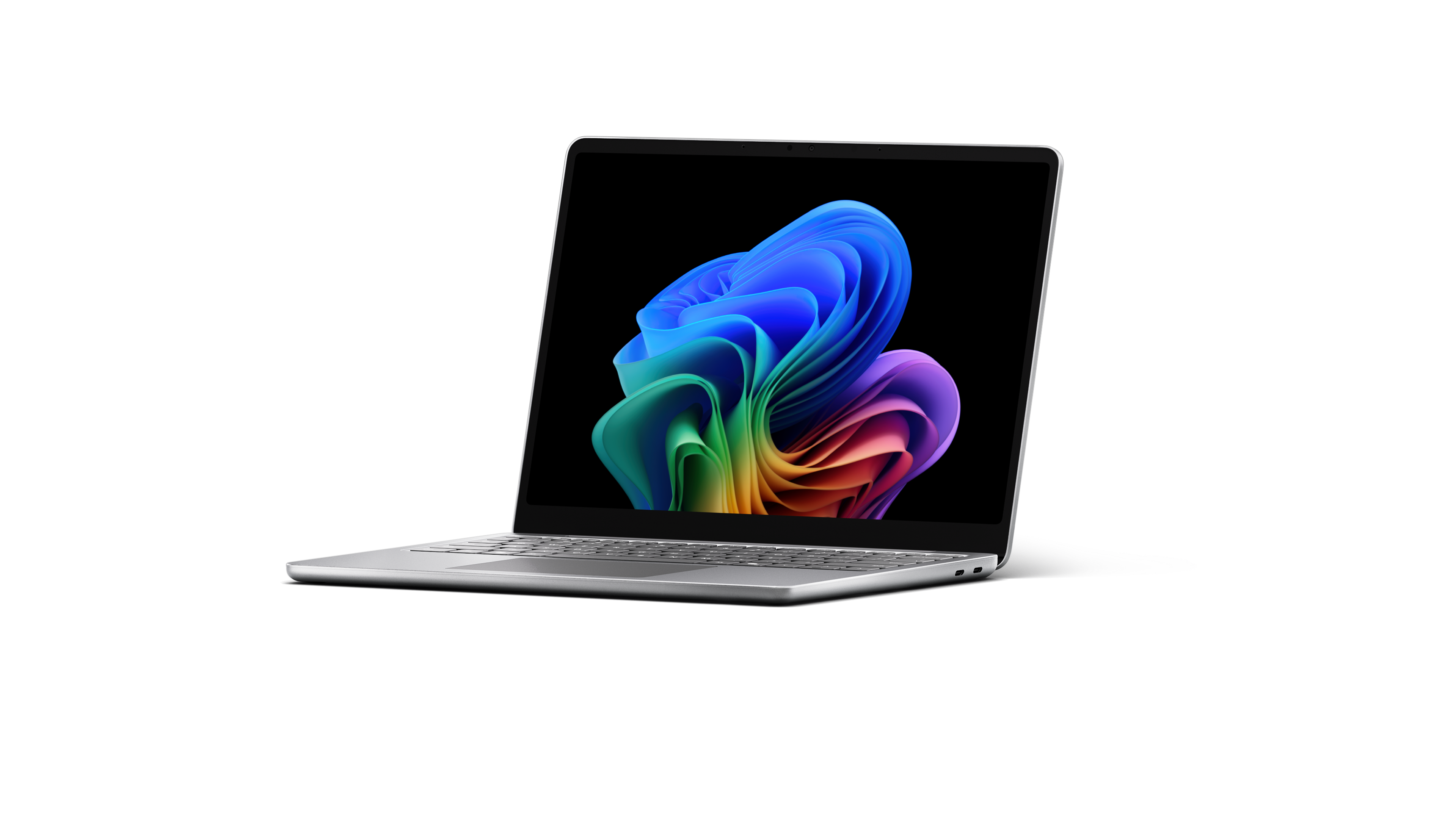 Un Surface Laptop de nouvelle génération ouvert tourné vers la gauche et affichant l’image de l’arc-en-ciel en forme de fleur