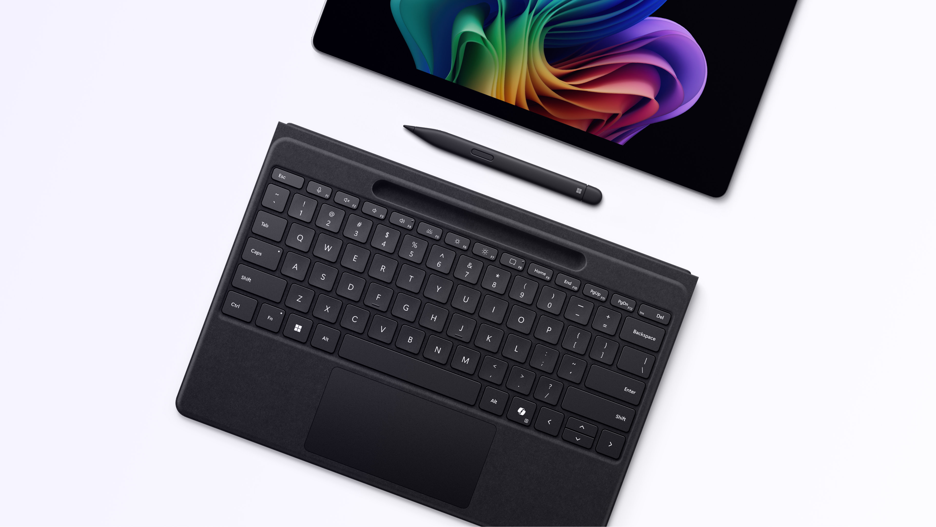 Un ordinateur portable Windows ouvert affichant l'image de la fleur arc-en-ciel avec un clavier amovible et un stylet, activé à la fois pour la saisie tactile et le jeu de touches, sur un fond gris.