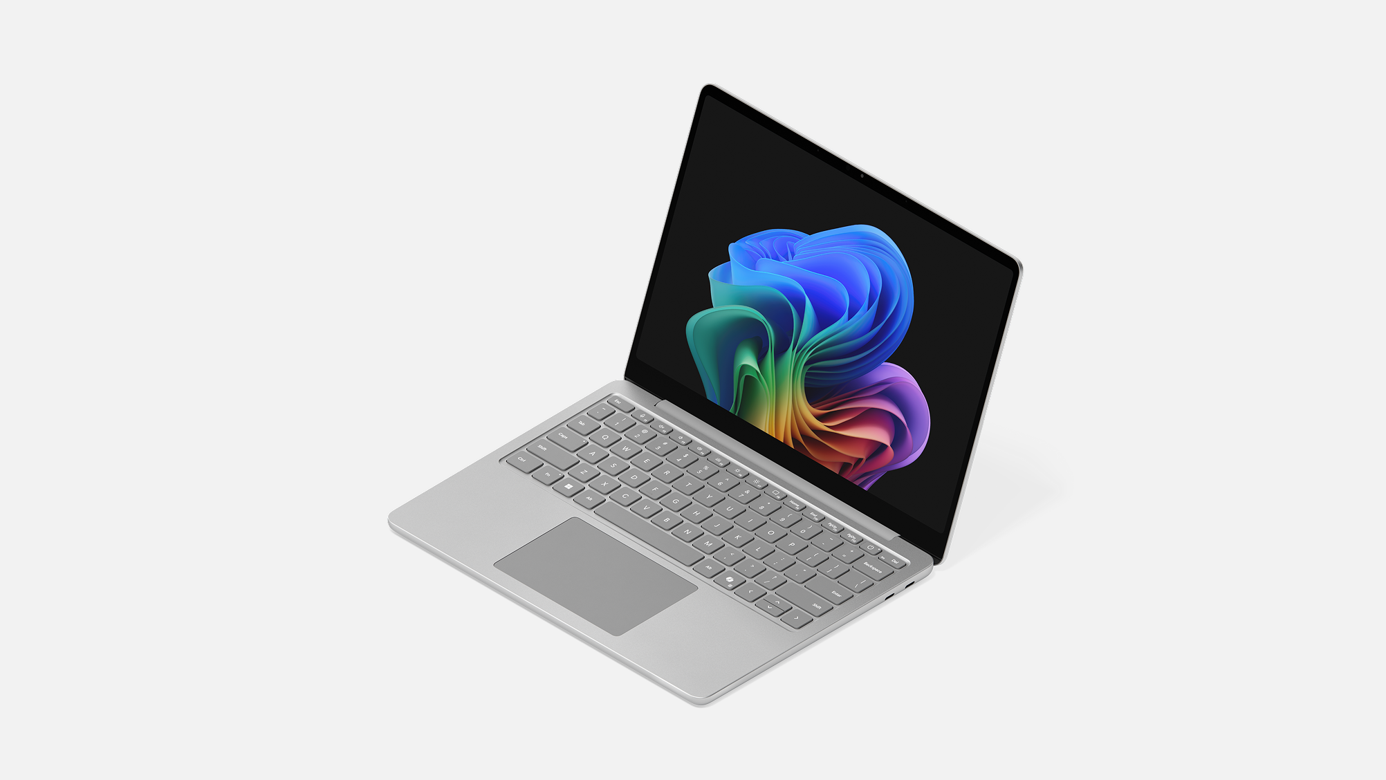 A Surface Laptop for Business, 13-inch | Intel facing left displaying the rainbow bloom image.